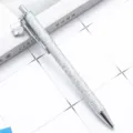 Silver glitter ballpoint pen with charming crystal clover pendant, stylish metal desk accessory. - Silver (Silver Hardware)