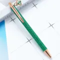 Green glitter ballpoint pen with rose gold clip and elegant green four-leaf clover pendant. - Christmas Green