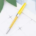 Yellow metal ballpoint pen with crystal rhinestones inside, elegant office stationery. - Yellow