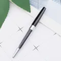 Elegant black and silver metal ballpoint pen with sparkling crystal filled barrel for office use. - Black