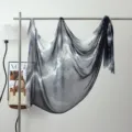 Detail shot of black and white ink wash modal scarf hanging on a metal rack, artistic drape. - Ink Wash #11