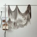 Detailed view of ink wash gradient modal shawl hanging on a metal rack with stylish decor. - Ink Wash #12