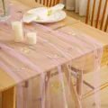 Pink mesh table runner with delicate floral embroidery, sheer fabric for dining room decor. - Floral A Purple