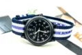 Black dial nylon strap military quartz watch detail view showcasing clear white numbers and band. - Fine Purple