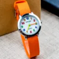 Children quartz watch with bright orange nylon strap and colorful numbers dial daily casual style. - Orange
