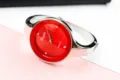 Detail shot of the red dial quartz bangle watch, featuring crystal hour markers and metal strap. - Silver Red