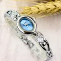Women silver quartz watch, blue oval dial, heart bracelet strap, elegant minimalist style. - Fashion / Silver & Light Blue