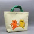 Cute corduroy tote bag with embroidered cartoon tigers and green handles for daily shopping. - Two Leaping Tigers