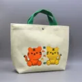 Cute cartoon tiger embroidery corduroy lunch tote bag with green handles for daily use. - Two Sitting Tigers