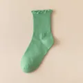 Green ribbed crew socks with cute ruffled lettuce edge, perfect for daily wear and outfits. - One Size / Green