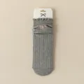 Grey ribbed knit women's mid-calf socks featuring sweet pink bow embroidery and ruffled cuffs. - Gray