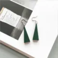 Detailed close-up of dark green triangular wooden earrings on magazine background - Solid Dark Green Triangle Style (6)