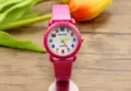 Kinder Quarzuhr Detailansicht mit rosa Lederarmband und bunten Ziffern auf dem Zifferblatt. - Fuchsia