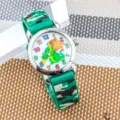 Orologio quarzo dinosauro bambini con cinturino silicone mimetico verde e quadrante colorato. - Drago di Fuoco