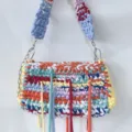 Handmade colorful crochet woven shoulder bag with stylish fringe and chain strap details. - Multicolor
