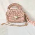 Handmade crochet shoulder bag detail, pink fabric strip weave texture with gold chain. - Khaki