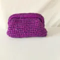 Metallic purple woven clutch bag detail showing handmade crochet texture and frame design. - Purple