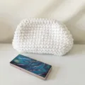 Handmade white crochet clutch bag for women, stylish thick knitted purse detail view. - White