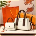 Detail view of white and brown handbag set featuring dual handles, contrast leather and golden hardware. - Gift Box Packing / Off White