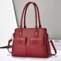 Red leather tote bag with double handles, spacious triple compartments and front pockets. - Red
