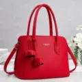 Red pebble leather top handle handbag with shoulder strap and stylish tassel detail. - L 31cm, W 14cm, H 22cm, Handle 17cm / Red
