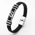 Detailed shot of black braided leather bracelet with stainless steel dollar sign accent. - Dollar
