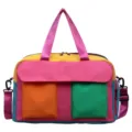 Color-blocked travel duffle bag with vibrant pink yellow and blue multi compartments. - Pink