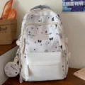 Witte studentenrugzak met schattig zwart vlinder- en sterrenpatroon en een klein tasje. - Rugzak Wit