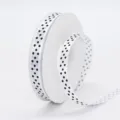 White polyester ribbon featuring black polka dots on spool, perfect for gift wrapping and DIY bows. - 1cm Width / Bleached White