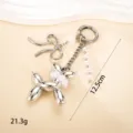 Stylish silver balloon dog keychain featuring elegant pearl and bow details for bag charm. - Pearl Balloon Dog Pendant