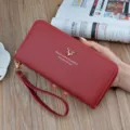 Red faux leather long wallet for women with secure zipper, wrist strap and metal deer logo. - Wine Red