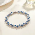 Elegant cross-inlaid blue zirconia bracelet detail view, sparkling gemstone women fashion jewelry. - Silver and Blue