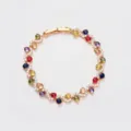 Colorful cubic zirconia cross bracelet, elegant luxury gemstone jewelry for women detail shot. - Gold + Multicolor Stone