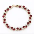 Stunning wave-shaped gold-tone bracelet detailed with brilliant red and clear zirconia stones. - Gold and Red