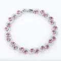 Close-up view of the intricate S-curve silver bracelet featuring sparkling pink zircons. - Silver and Pink