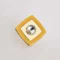 Close-up of square yellow acrylic scarf buckle with gold metal and center rhinestone. - Yellow
