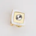 Detailed shot of a square scarf ring with gold metal frame white acrylic and central rhinestone. - White