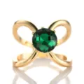 Elegant gold-tone scarf ring with a central green crystal and bow design, perfect for styling. - Gold Green Stone