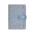 Blue denim passport holder with snap button and card slots for travel and daily use. - Light Blue