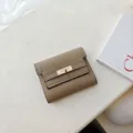 Brown textured leather short trifold wallet with gold turn lock clasp for women daily use. - Khaki