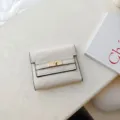 Minimalist off-white short trifold wallet with gold turn-lock closure elegant design - White