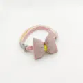 Close-up detail of the pink houndstooth pet collar featuring a cute bow and secure buckle. - 1.0 (19-32cm) / Pink
