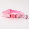 Close-up of pink pet collar detail, featuring cute paw print patterns and metal bell. - Paw Print Style / Pink