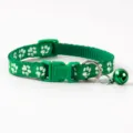 Green pet collar featuring white paw prints, safety quick release buckle, and cute bell detail. - Paw Print Style / Dark Green