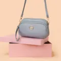 Elegant women's multi-pocket crossbody bag in soft grey PU leather with gold tone hardware. - Deep purple
