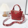 Red quilted leather shoulder bag featuring stylish wide strap and golden hardware. - Jujube Red