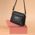 Chic black quilted crossbody bag for women, featuring cute bow embroidery and adjustable strap. - Black