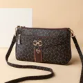 Stylish women's crossbody shoulder bag with monogram pattern and metal buckle detail. - Brown-4