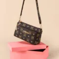 Brown monogram crossbody bag featuring multiple compartments and adjustable shoulder strap. - Letter M