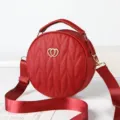 Red round crossbody bag for women, stylish quilted shoulder bag with wide strap and chic heart. - Wine Red